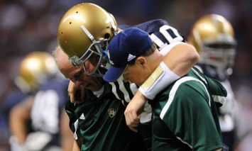 Notre Dame Fighting Irish Quarterback Dayne Crist (#10) is helped off the field after injuring his knee against Washington State at the Alamodome in San Antonio, Tx. (Photo - IconSMI)