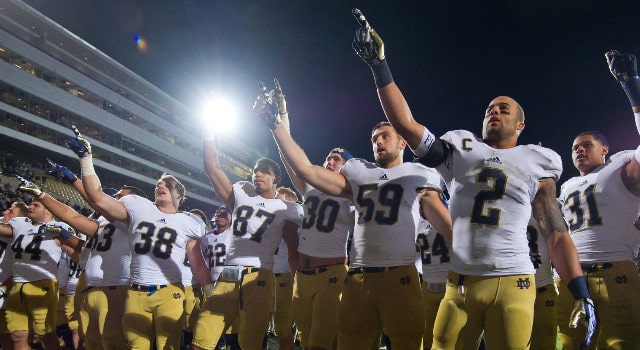 Notre Dame Fighting Irish cornerback Bennett Jackson (2) and linebacker Jarrett Grace (59) celebrate with their teammates after Notre Dame defeated the Purdue Boilermakers 31-24 at Ross-Ade Stadium. Mandatory Credit: Matt Cashore-USA TODAY Sports