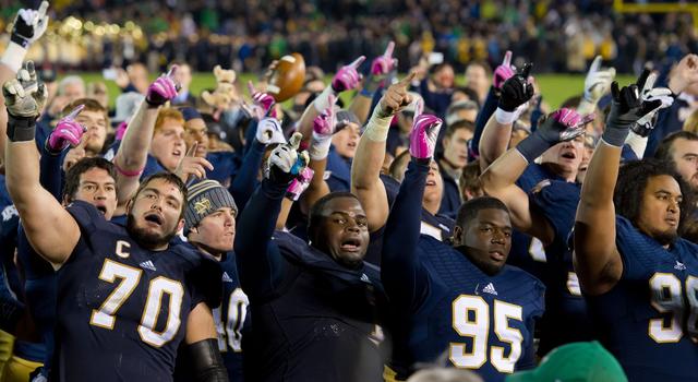 Oct 19, 2013; South Bend, IN, USA; Notre Dame Fighting Irish offensive tackle Zack Martin (70), nose tackle Louis Nix (1), defensive lineman Marquis Dickerson (95), and nose tackle Kona Schwenke (96) sing the Notre Dame Alma Mater after Notre Dame defeated the USC Trojans 14-10 at Notre Dame Stadium. Mandatory Credit: Matt Cashore-USA TODAY Sports