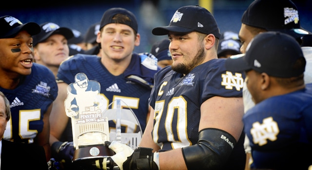 Notre Dame offensive tackle Zack Martin (70) is awarded the game's MVP trophy against the Rutgers Scarlet Knights in the Pinstripe Bowl at Yankees Stadium. Notre Dame won the game 29-16. Mandatory Credit: Joe Camporeale-USA TODAY Sports
