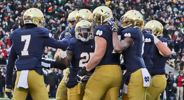 Notre Dame Fighting Irish running back Tarean Folston (25) is congratulated by teammates after scoring a touchdown against the Northwestern Wildcats at Notre Dame Stadium. Mandatory Credit: Brian Spurlock-USA TODAY Sports