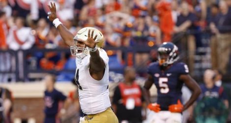 Sep 12, 2015; Charlottesville, VA, USA; Notre Dame Fighting Irish quarterback DeShone Kizer (14) celebrates after throwing the game-winning touchdown pass against the Virginia Cavaliers with twelve seconds left in the fourth quarter at Scott Stadium. The Fighting Irish won 34-27. Mandatory Credit: Geoff Burke-USA TODAY Sports