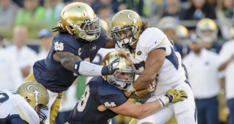 Sep 19, 2015; South Bend, IN, USA; Georgia Tech Yellow Jackets running back Patrick Skov (7) is tackled by Notre Dame Fighting Irish linebacker Jaylon Smith (9) and linebacker Greer Martini (48) in the fourth quarter at Notre Dame Stadium. Notre Dame won 30-22. Mandatory Credit: Matt Cashore-USA TODAY Sports