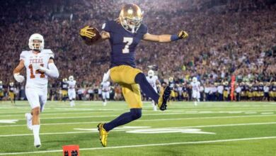 Sep 5, 2015; South Bend, IN, USA; Notre Dame Fighting Irish wide receiver William Fuller (7) jumps into the end zone for a touchdown in front of Texas Longhorns safety Dylan Haines (14) in the third quarter at Notre Dame Stadium. Notre Dame won 38-3. Mandatory Credit: Matt Cashore-USA TODAY Sports