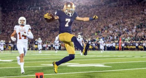 Sep 5, 2015; South Bend, IN, USA; Notre Dame Fighting Irish wide receiver William Fuller (7) jumps into the end zone for a touchdown in front of Texas Longhorns safety Dylan Haines (14) in the third quarter at Notre Dame Stadium. Notre Dame won 38-3. Mandatory Credit: Matt Cashore-USA TODAY Sports