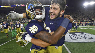 Notre Dame OL Robert Hainsey (right) celebrates with S Isaiah Robertson
