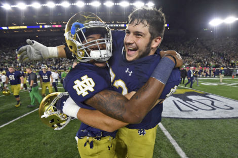 Notre Dame OL Robert Hainsey (right) celebrates with S Isaiah Robertson