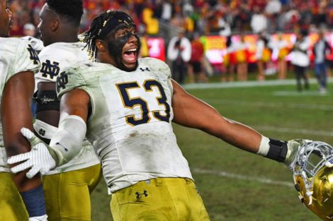 Notre Dame DE Khalid KAreem celebrates Notre Dame's perfect regular season following their win over USC