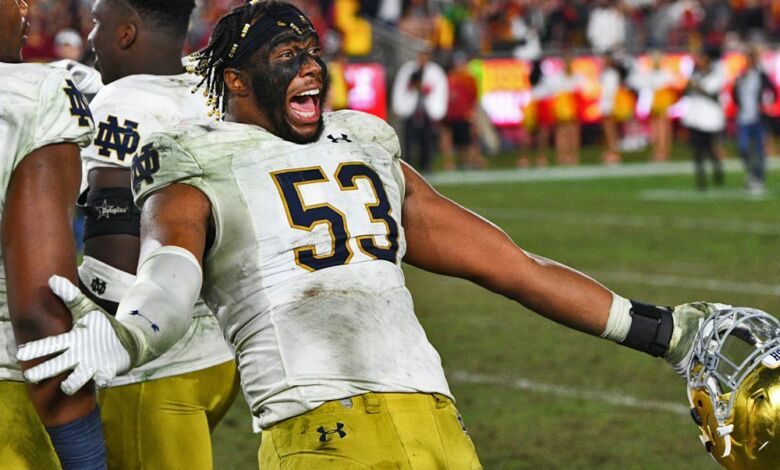 Notre Dame DE Khalid KAreem celebrates Notre Dame's perfect regular season following their win over USC