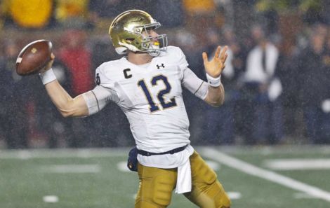 Notre Dame Quarterback Ian Book attempting a pass versus Michigan