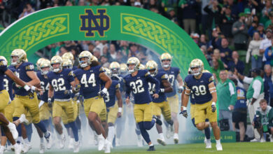 Notre Dame football team running out of the tunnel